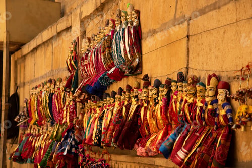 Preview: Colorful Rajasthani puppets hanging in the street of Jaisalmer, India.