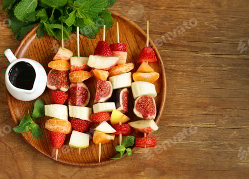 Preview: Colorful Fruit Skewers with Dipping Sauce on Wooden Plate
