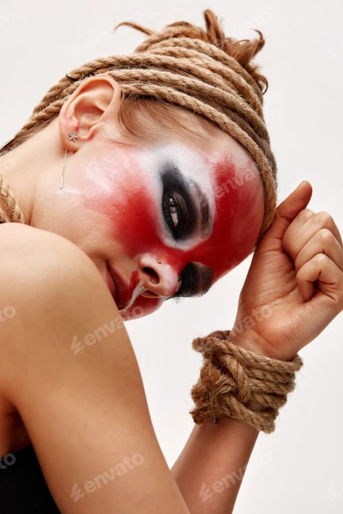 Preview: Portrait of young beautiful girl with colorful face painting with an animal flow move in studio