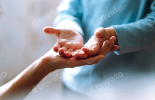 Preview: Mom helps her chaild wash her hands. They are rubbing their hands together creating foam with soap.