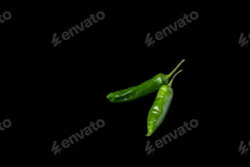 Preview: Green chili peppers on black background.