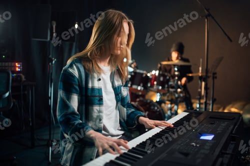 Preview: Girl playing synthesizer in recording studio.
