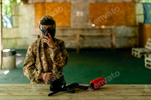 Preview: in the wild in the hangar for instructions a pintball coach puts on a uniform before the game full