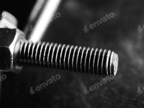 Preview: Closeup shot of metal screw threads isolated on the black background