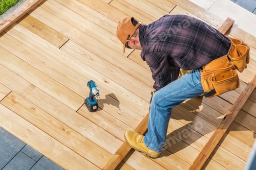 Preview: Worker Installing Wooden Flooring in Outdoor Daylight Project