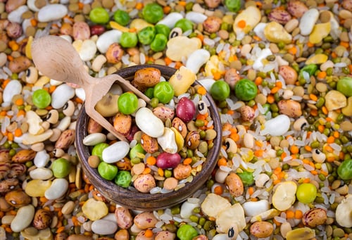 Preview: Wooden Bowl and Spoon Surrounded by Dried Beans