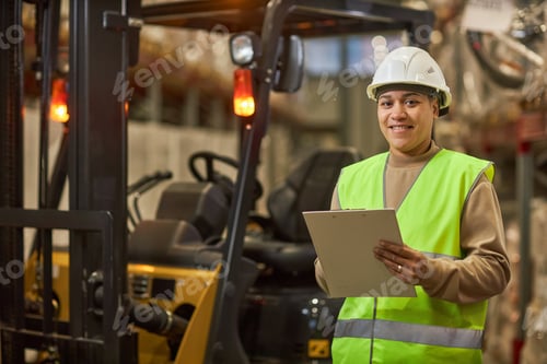 Preview: Smiling black woman looking at camera in warehouse