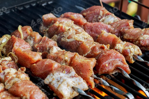 Preview: Marinated shashlik preparing on a barbecue grill over charcoal