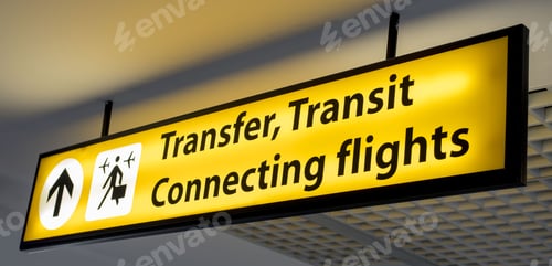 Preview: Yellow and black "Transfer, Transit, Connecting flights" information board sign at airport