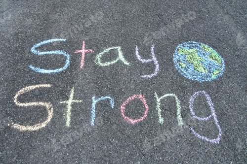 Preview: Stay Strong! Inspirational message in pastel colored sidewalk chalk encouraging people around world