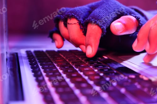 Preview: Close up of hacker hand stealing data from laptop