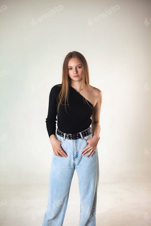 Preview: Lovely slender cover lady in fashion denim clothes posing at white studio