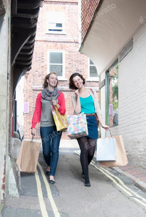 Preview: Teenage girls carrying shopping bags