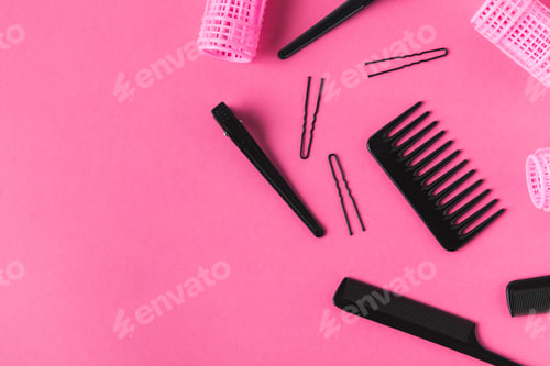 Preview: flat lay with curlers and hairdressing tools, on pink