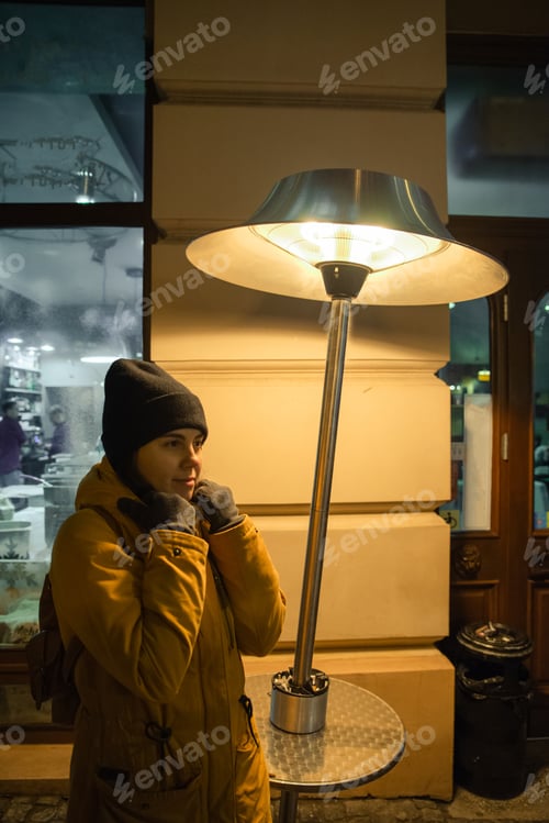Preview: Woman Standing Outdoors Near Heater Winter Time