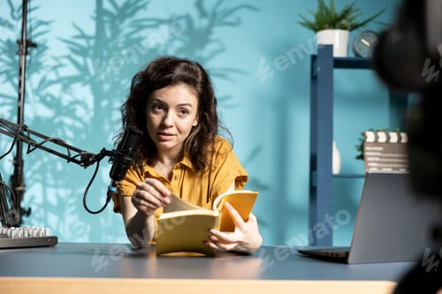Preview: Joyous woman presenting and reading new novel from author