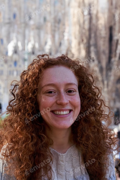 Preview: Portrait of smiling tourist with red hair outdoors looking at the camera smiling.