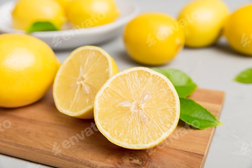 Preview: Top view with copy space for fresh and ripe lemons on cutting board