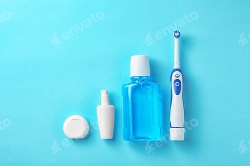 Preview: Flat lay composition with electric toothbrush and oral hygiene products on color background