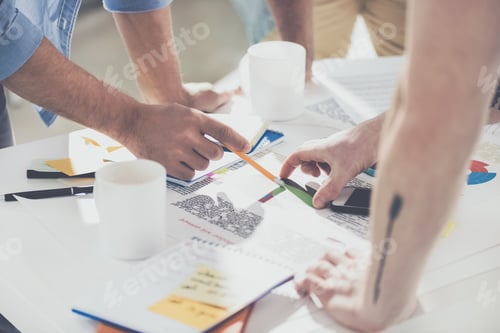 Preview: cropped shot of businessmen pointing at diagrams and working on new project at office