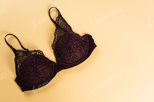 Preview: Top view of lace bra on beige background