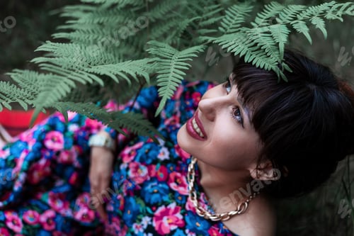 Preview: Romantic portrait of a woman in a fern in the forest. Art woman natural makeup resting in nature. Gr