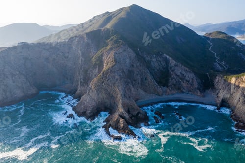 Preview: Ocean waves splash against rock on island