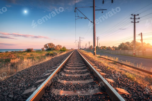 Preview: Railroad and blue sky with moon at sunset in summer