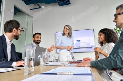 Preview: Diverse executive team people discussing company strategy at board meeting.