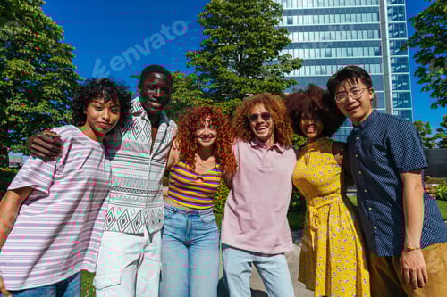 Preview: Multiethnic group of young friends meeting and having fun outdoors
