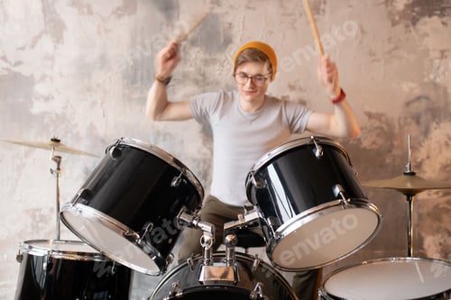 Preview: Young man in a red hat playing the drums