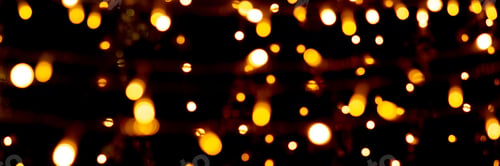 Preview: Blurry garland lights on a dark background. Festive Christmas and New Year background. Soft focus