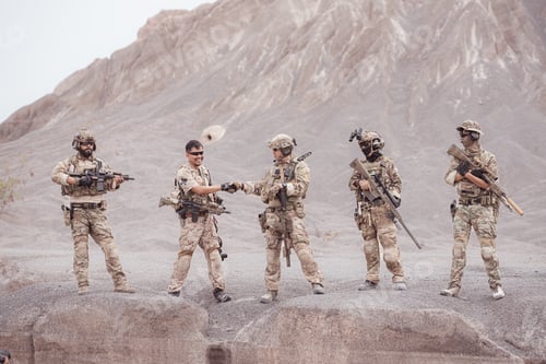 Preview: Soldiers in camouflage military uniforms carrying weapons Reconnaissance missions in rugged mountain