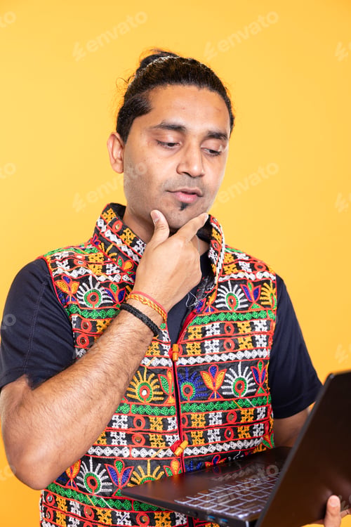 Preview: Pensive man thinking how to solve business tasks on laptop