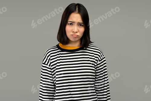 Preview: Sad unhappy woman looking at camera with pout lips, being upset of bad news
