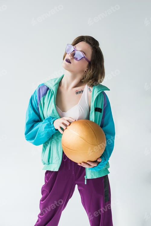 Preview: portrait of fashionable woman in vintage clothes with golden ball in hands isolated on grey