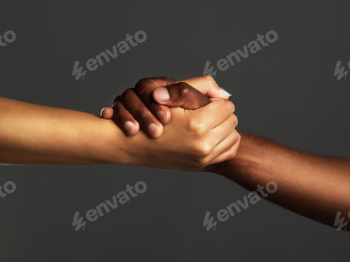 Preview: Studio shot of two unrecognizable people holding hands against a grey background