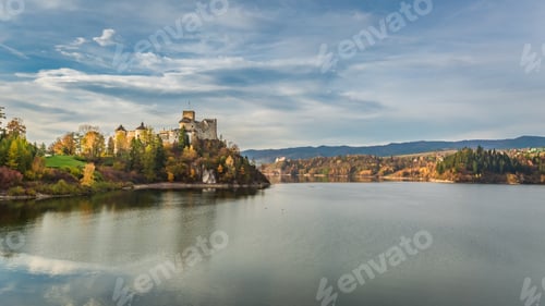 Preview: Stunning castle by the lake at dusk in autumn