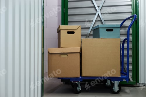 Preview: Cardboard Boxes on Trolley Being Moved Inside Self Storage Facility