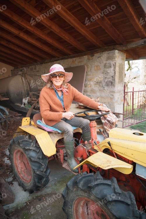 Preview: Farmer woman driving tractor in barn celebrating international workers' day