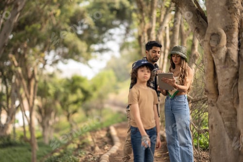 Preview: Family using a digital tablet while walking on a park