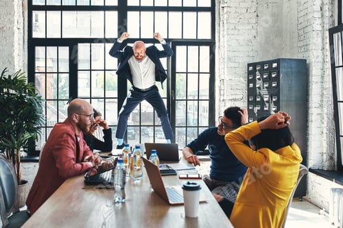 Preview: Angry businessman shouting at his workers with an expressive look