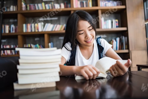 Preview: Young woman reading book sitting indoor in urban cafe.