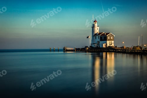 Preview: White lighthouse reflected in the sea under the beautiful sky