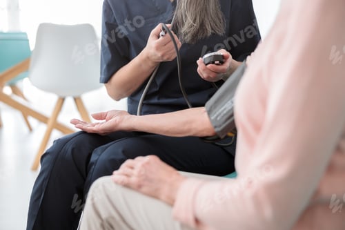 Preview: Female pediatrician visiting old woman at home