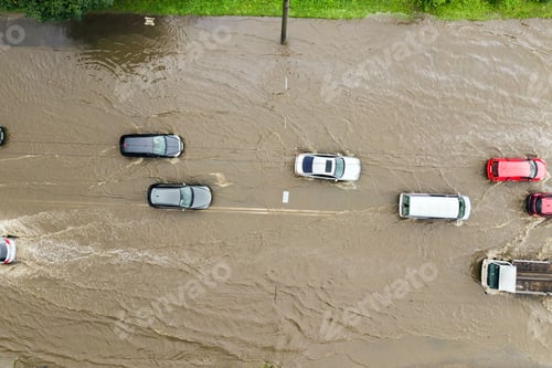 Preview: Aerial view of traffic cars driving on flooded road with rain water