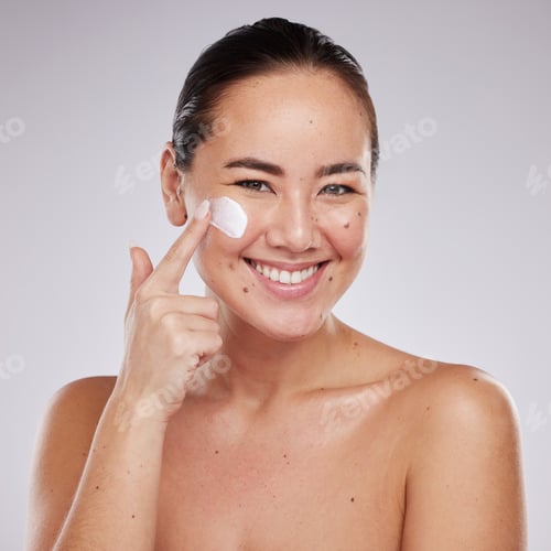 Preview: Portrait, skincare and face cream for woman in studio for wellness, grooming and cosmetics on grey