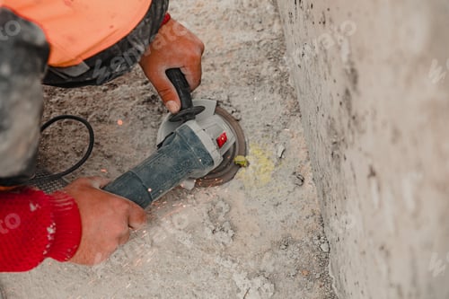 Preview: A construction worker using a rock-drill to dig the ground at a construction site