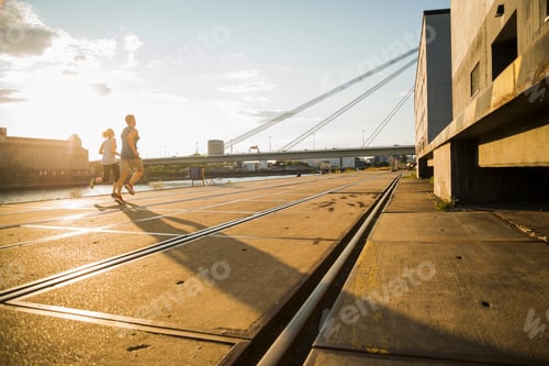 Preview: Young couple running by the riverside