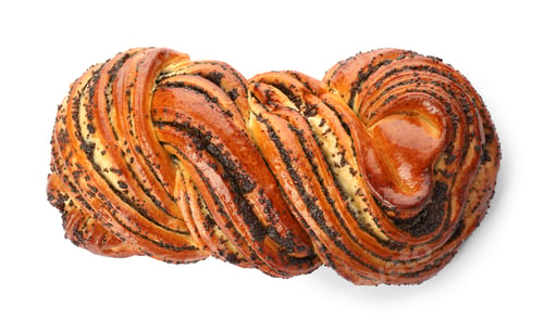 Preview: Tasty sweet bun with poppy seeds on white background, top view